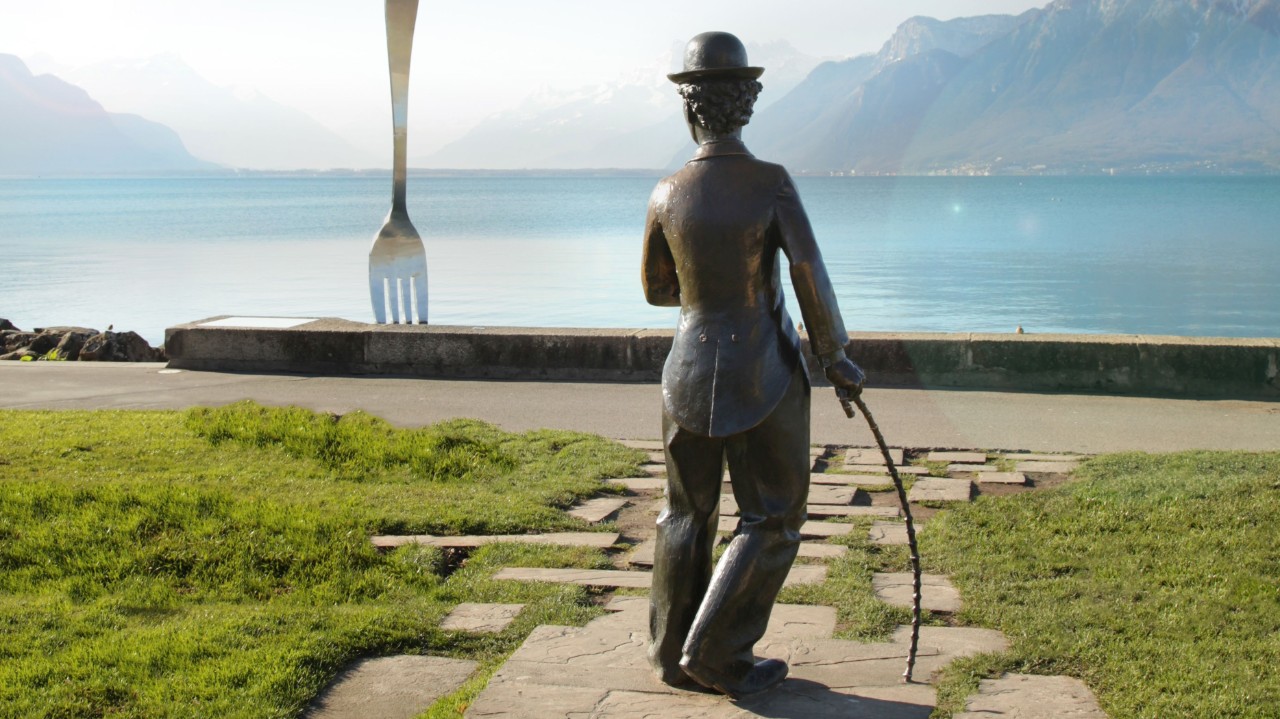 A fork stuck into the lake and the back of the Chaplin statue can be seen from the promenade.