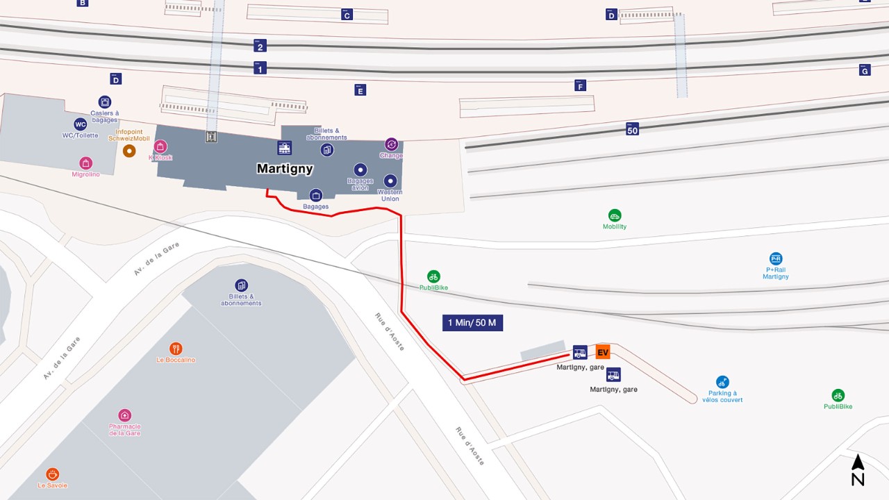 The map shows a bird’s eye view of Martigny railway station, with south at the bottom and north at the top of the map extract. To get to the replacement bus, walk from the arrival platform through the station towards the main entrance on Avenue de la Gare. Cross the road on your left and continue walking a few metres along Rue d’Aoste until you reach the bus stop. The distance is about 50 metres and takes 1 minute to walk.
