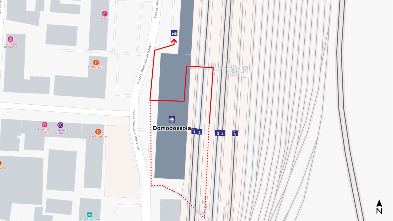 The map shows a bird’s eye view of Domodossola railway station, with south at the bottom and north at the top of the map extract. To get to the rail replacement bus, go from your arrival platform through the main station hall and then turn right. 
The distance is about 240 metres and takes 3 minutes to walk.